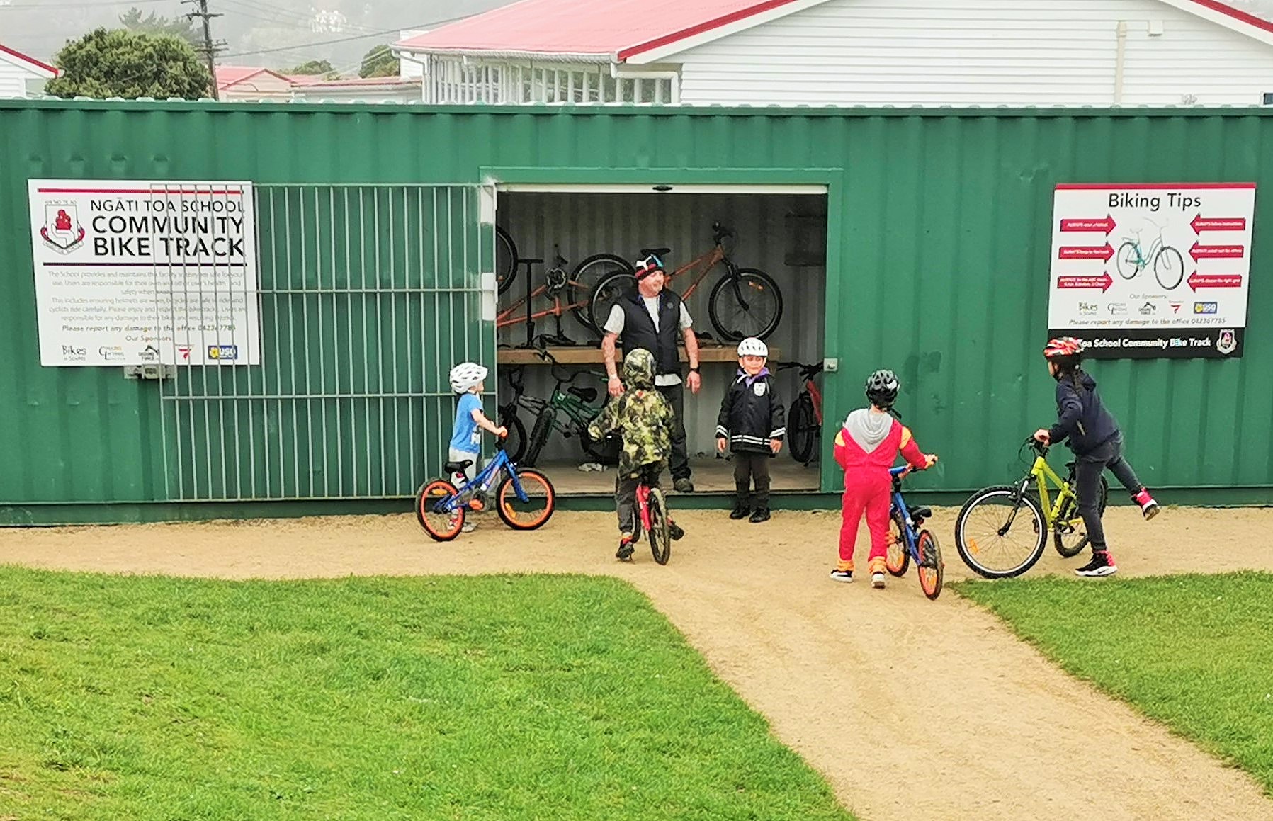 Glen the caretaker helps students at the Ngati Toa bike shed.