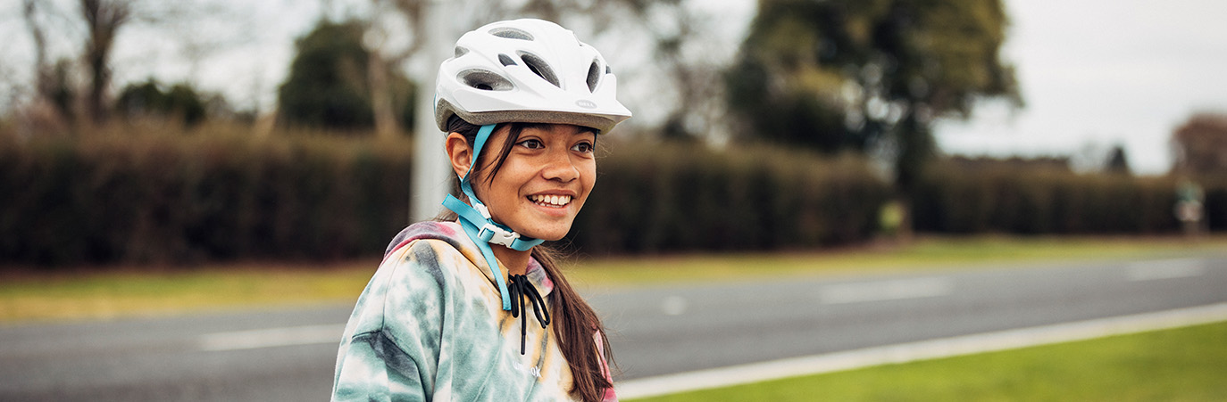 Girl wearing bicycle helmet.