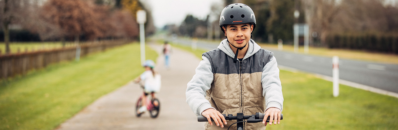 Young man rides scooter