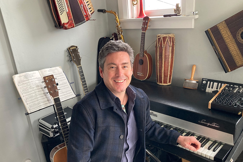 Music teacher Andrew Pennell sits at his keyboard.